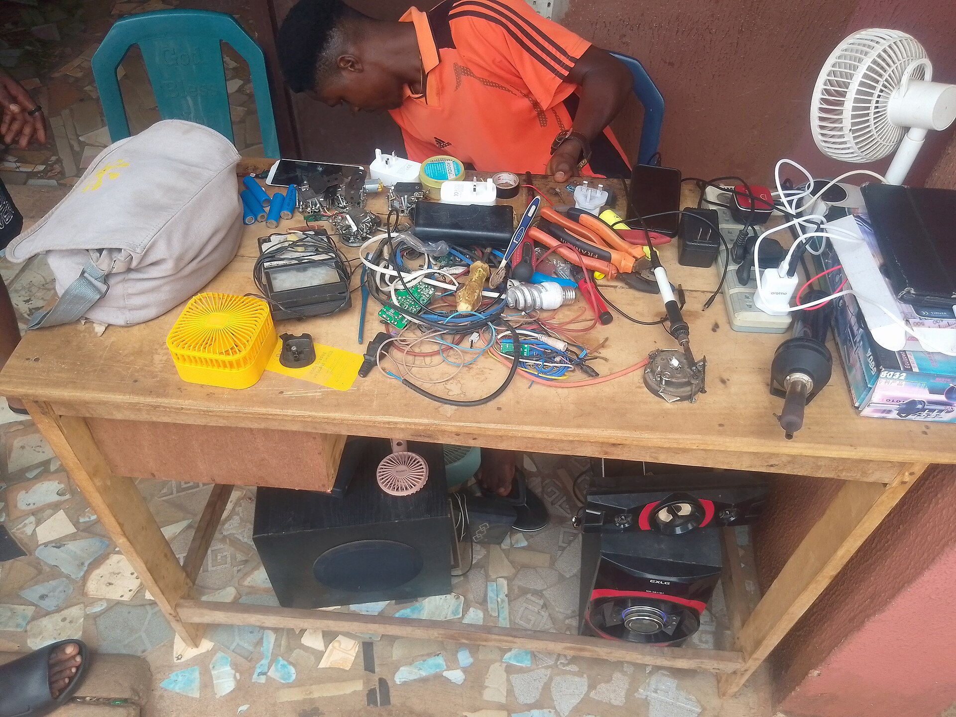 Technician working at an electronics repair bench